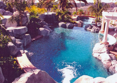 Beautiful pool with a unique geometric design and landscaped surroundings.