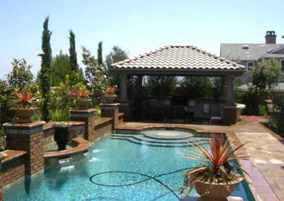 Backyard pool with custom design and comfortable lounging area.