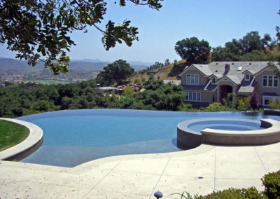 Contemporary poolscape with a spacious deck for relaxation.
