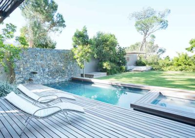 Modern poolscape featuring a sleek pool and minimalistic landscaping.