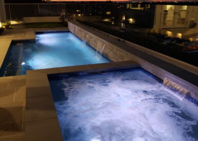 Completed poolscape with a scenic backyard view.