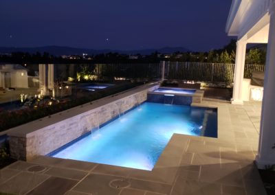 Serene poolside setting with a sunset view and cozy seating.