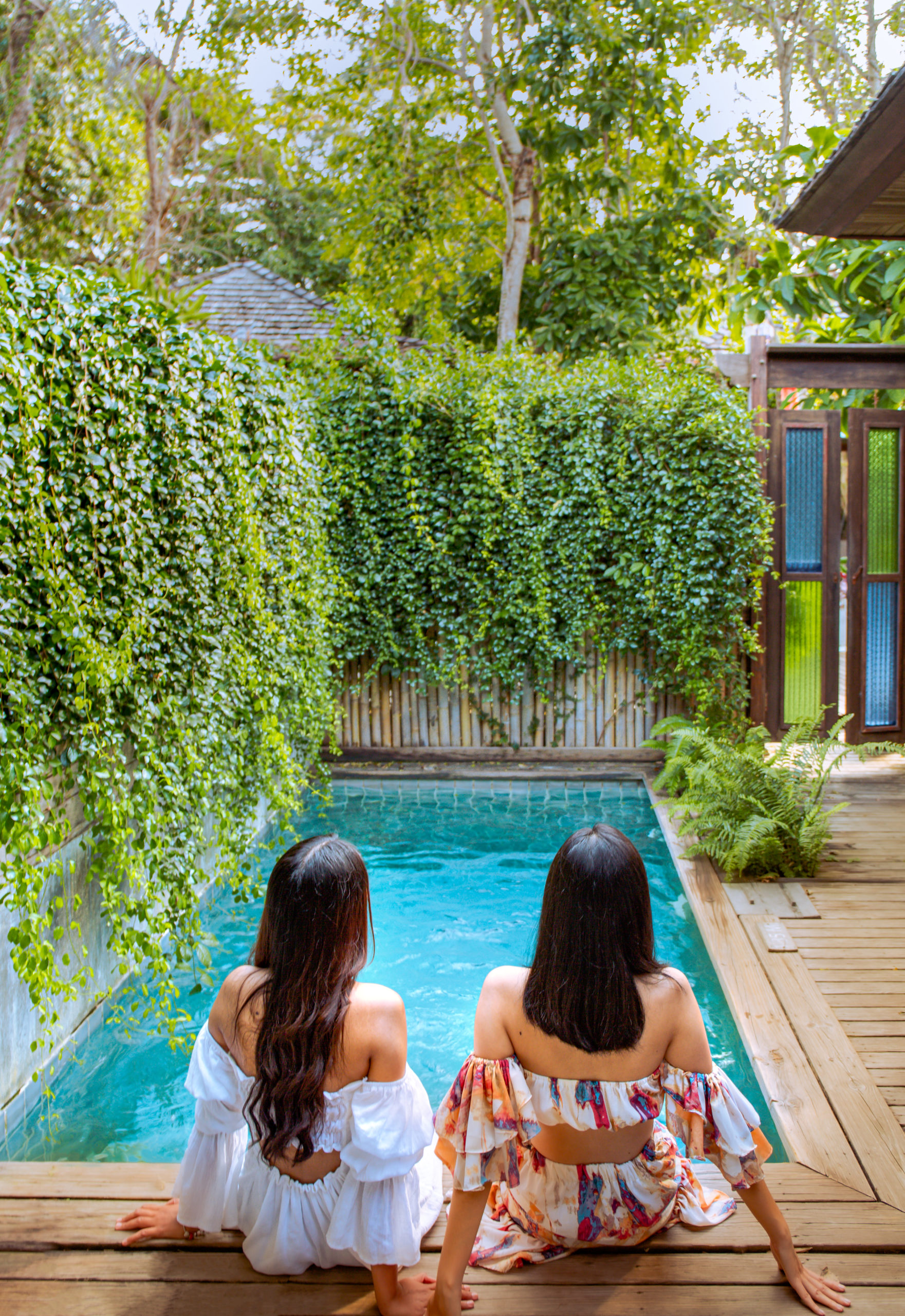 lapaz-3 Couple relaxing near a lush, tropical poolscape.